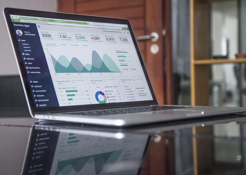 Person working on grant proposal at a clean desk setup with financial documents