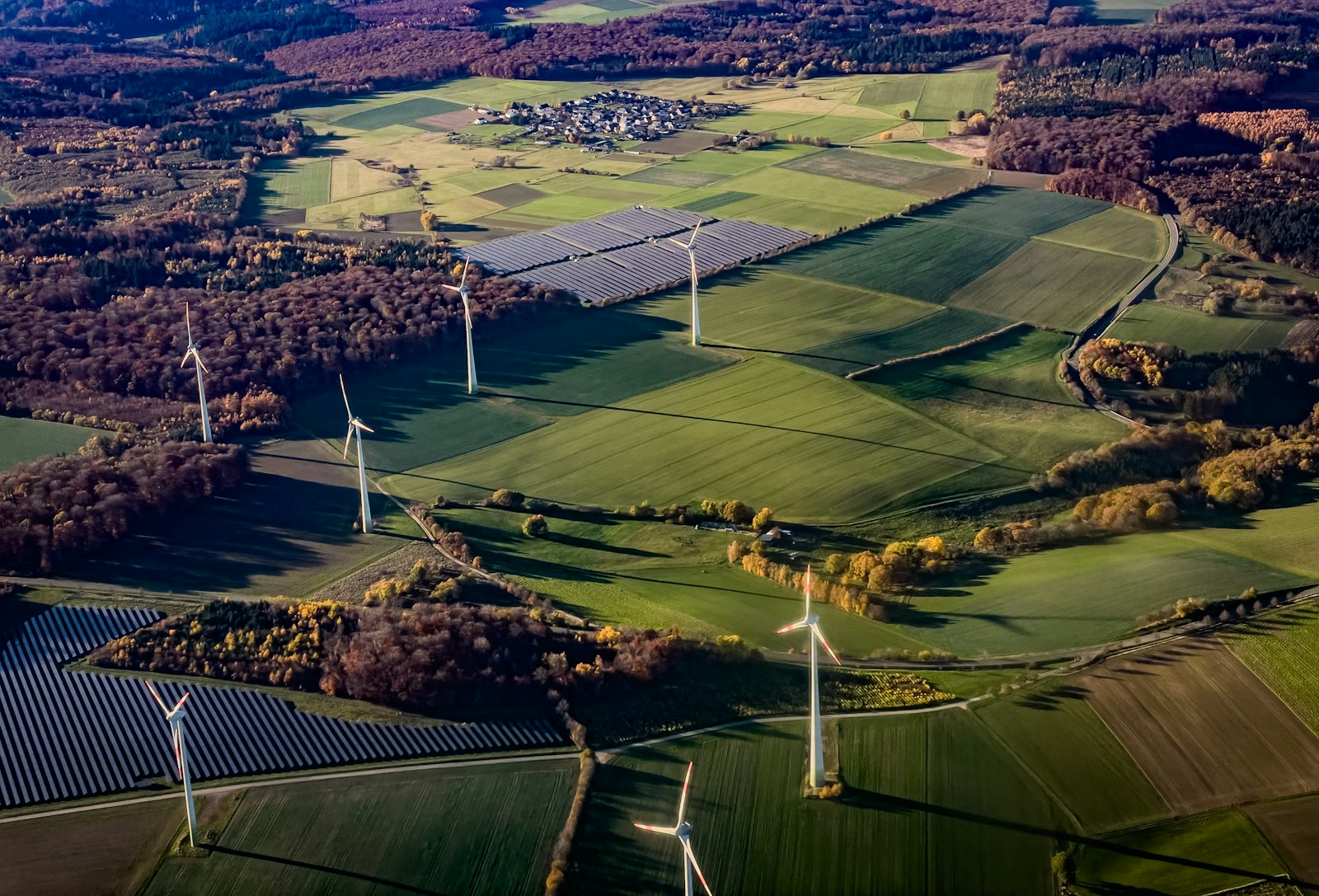Wind turbines and solar panels across a rural landscape, the kind of clean energy project USDA REAP grants fund